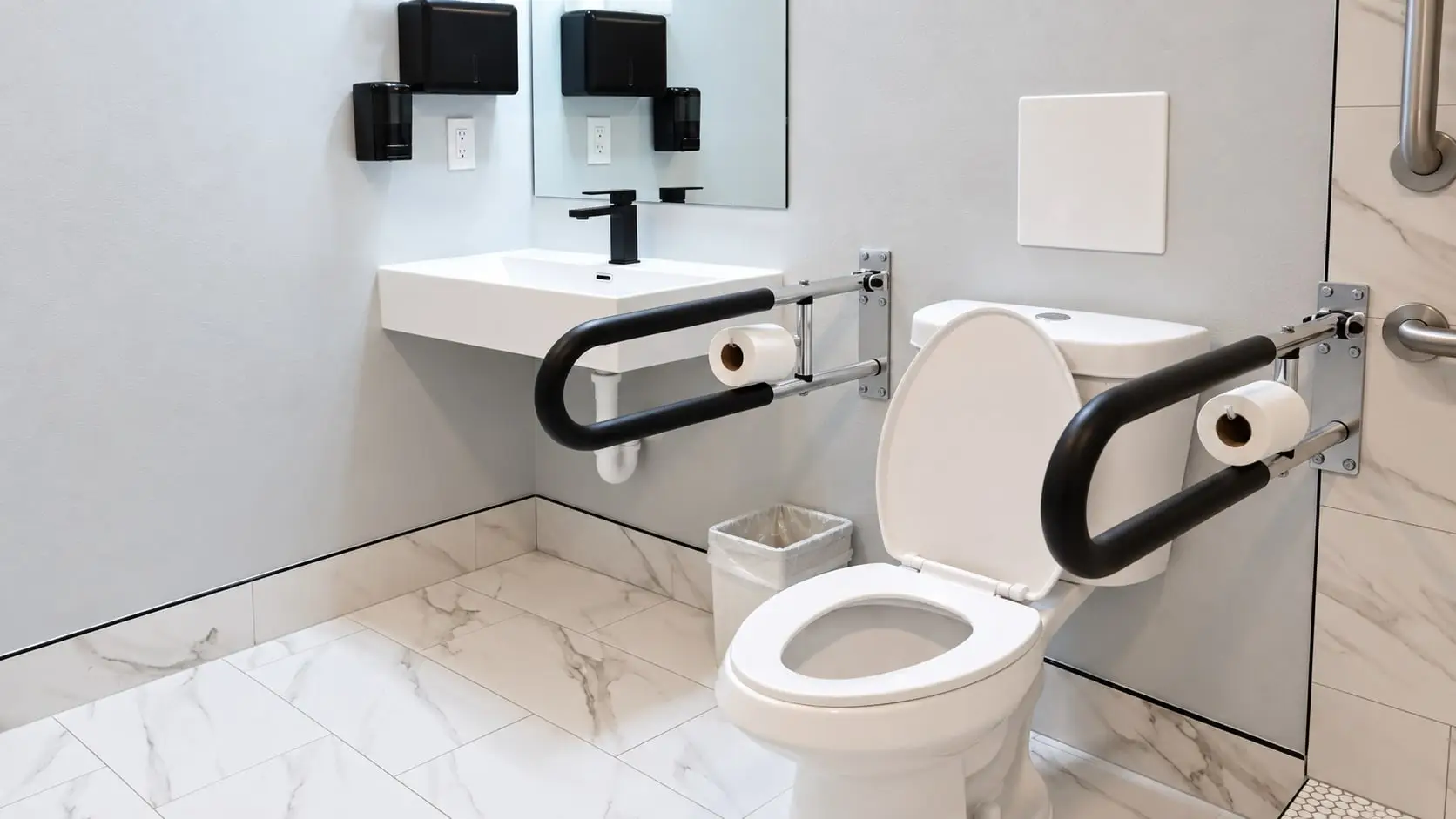 Toilet with fold-down grab bars on both sides