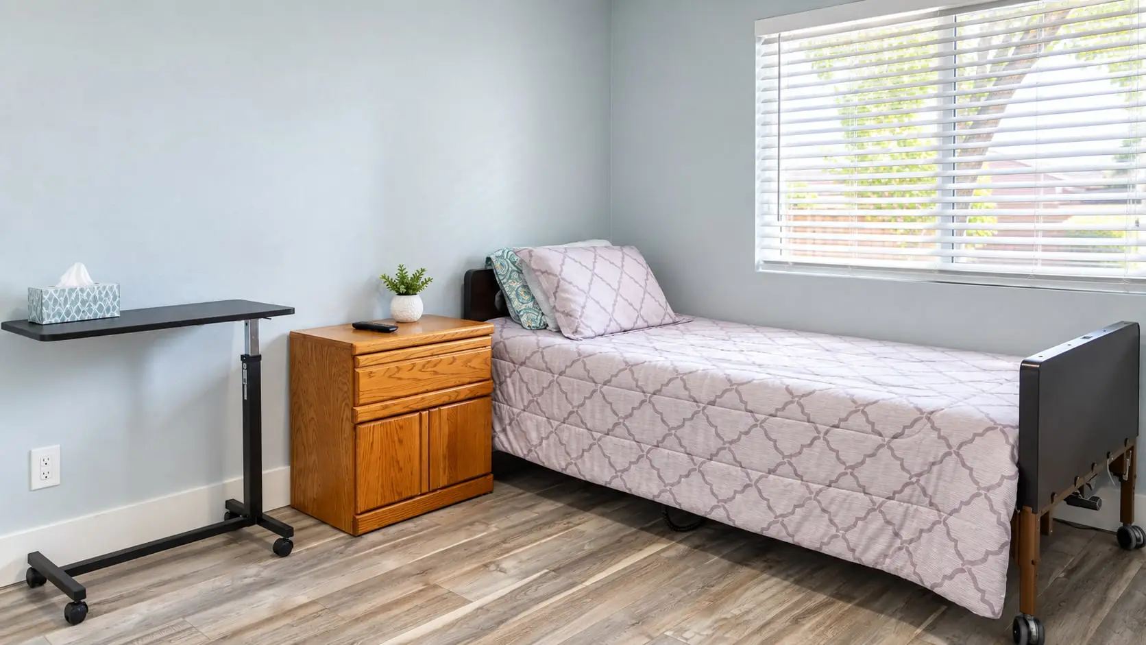 Bedroom with a single bed, overbed table and nightstand