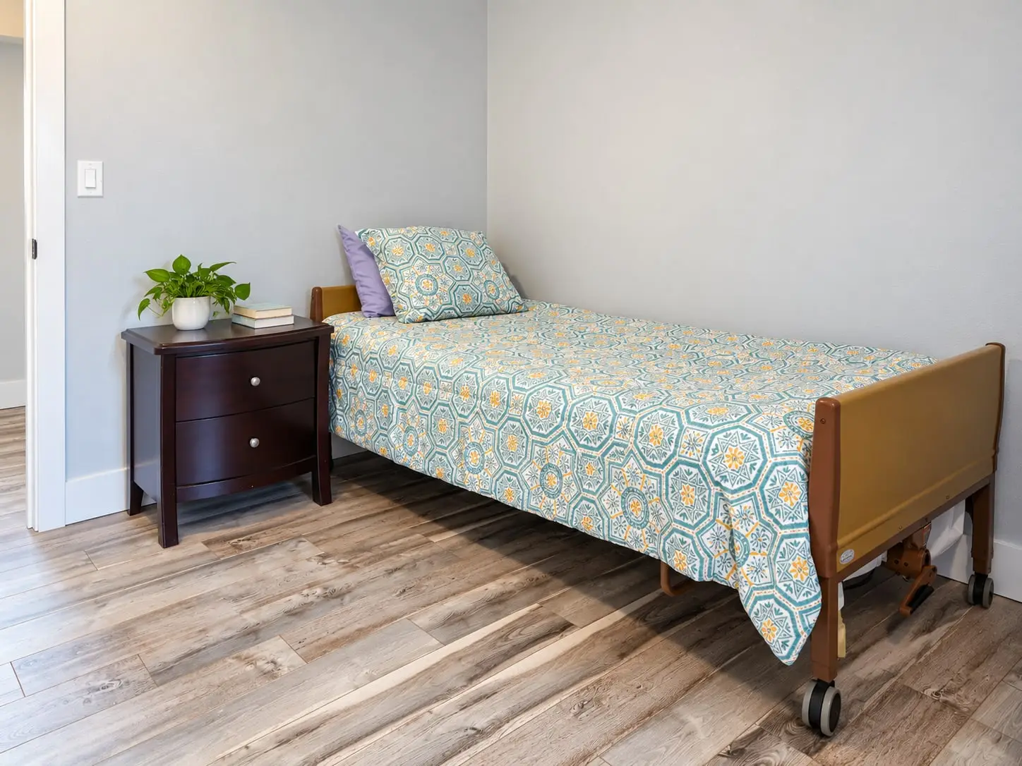 Bedroom with a single bed and a dark wood nightstand