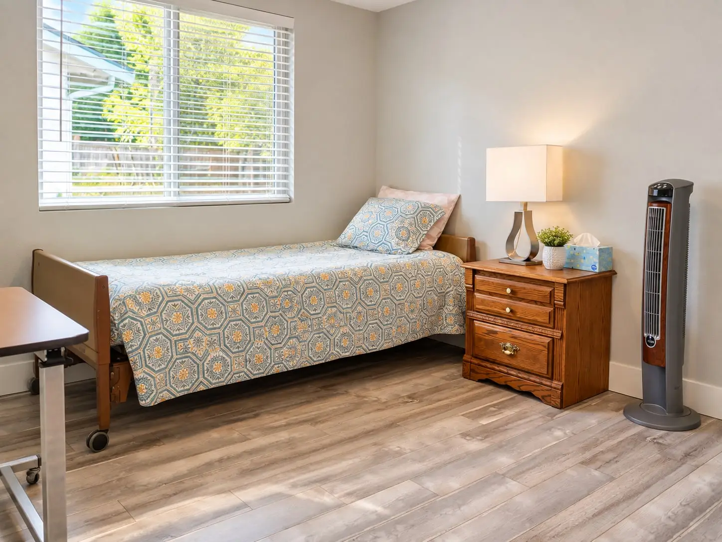 Bedroom with a single bed, nightstand and lamp beside a window