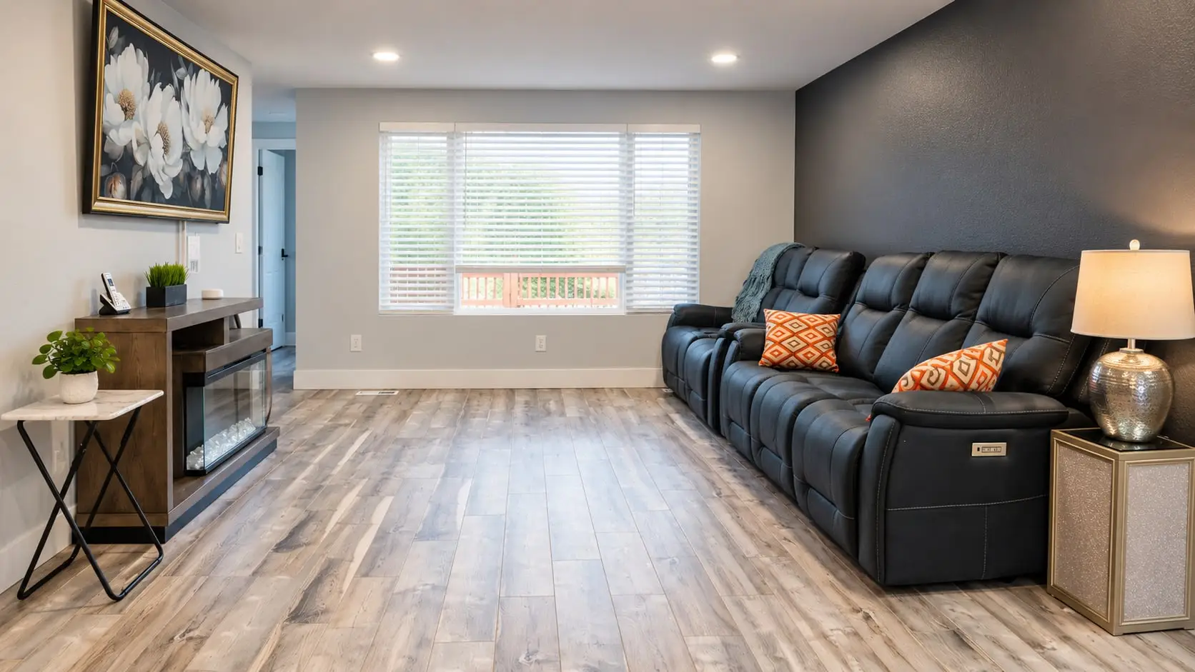 Living room seen from the corner, with sofa and side tables